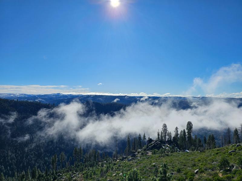 Sierra Nevada mountains with clouds and fog above highway 50.